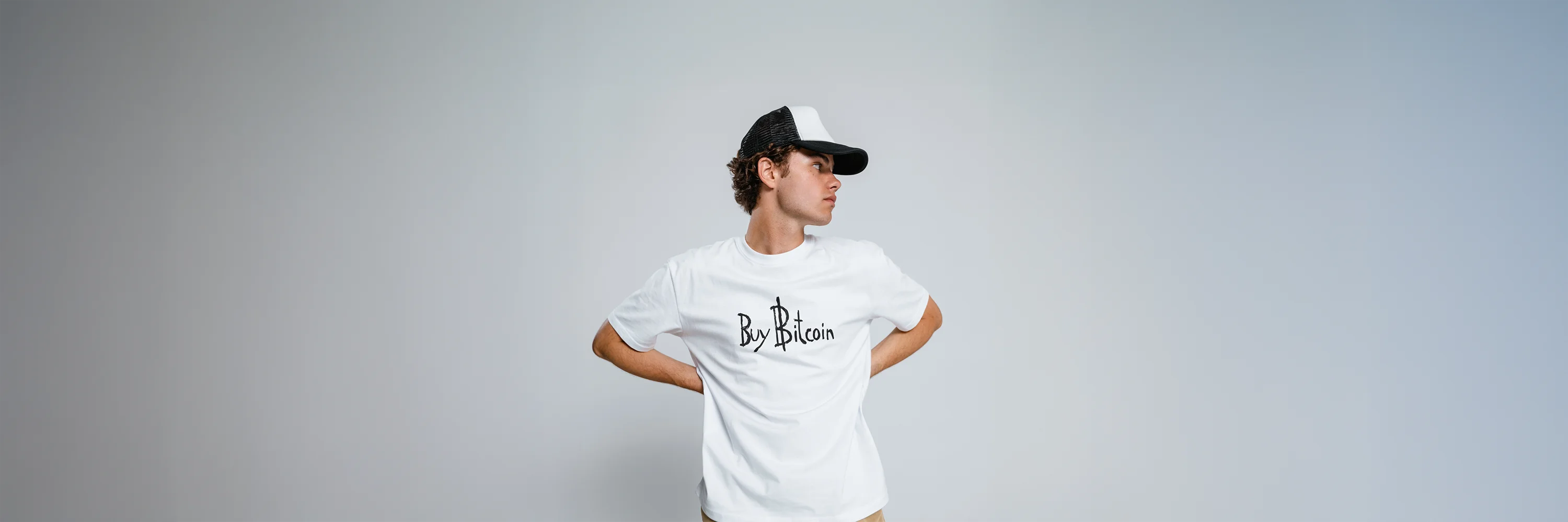 Model wearing white oversized T-Shirt with legendary Meme inspired Buy Bitcoin design. premium streetwear by CUKIDRIP
