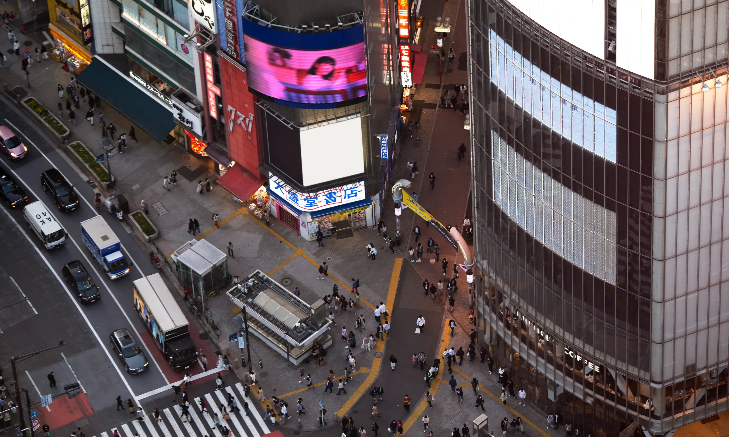 Aerial view of Tokyo street with crosswalks and neon signs, used as streetwear lifestyle background. Desktop Image by CUKIDRIP